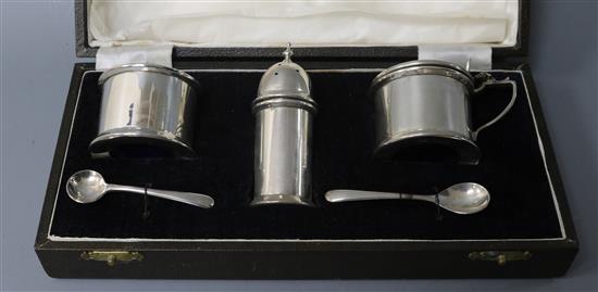 A cased 1930s silver three piece condiment set.